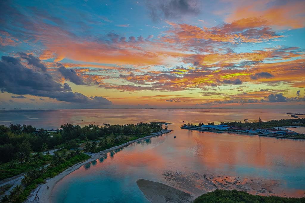Colourful tropical sunset over a calm Maldives lagoon