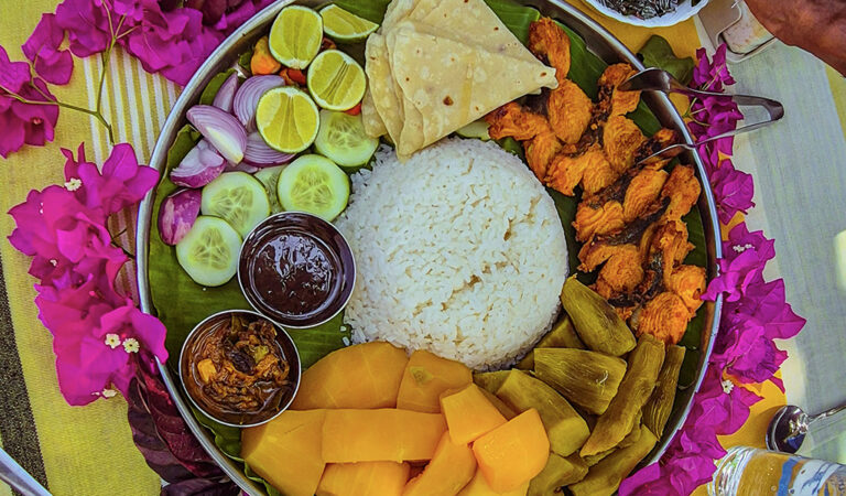 Traditional Maldivian lunch plate with rice and curries in Addu