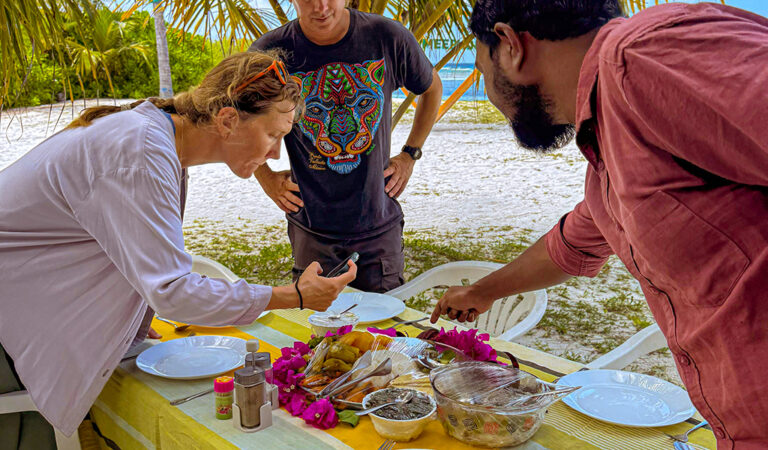 Guests sharing traditional Maldivian food on a local island in Addu